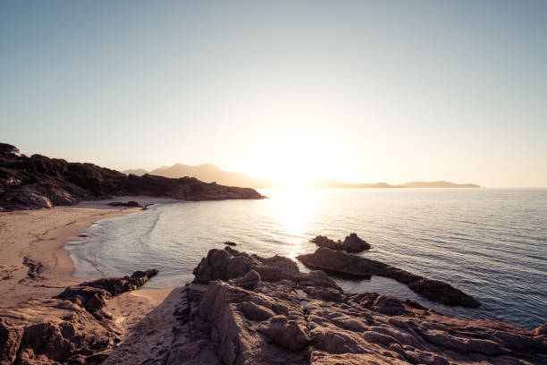 istock Sun setting over beach and calvi citadel in Corsica 1207451644