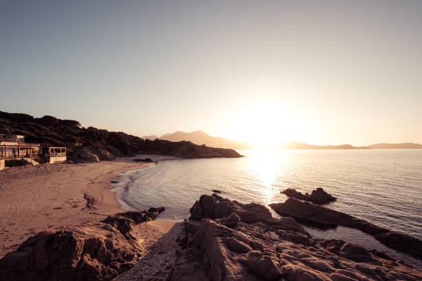 istock Sun setting over beach and calvi citadel in Corsica 1207451650