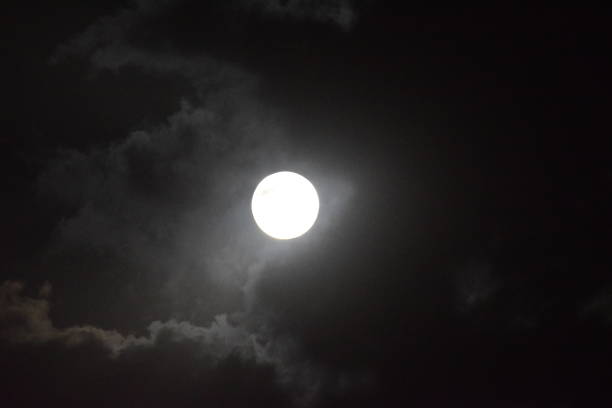 istock Full moon view during cloudy night in the sky 1207451712