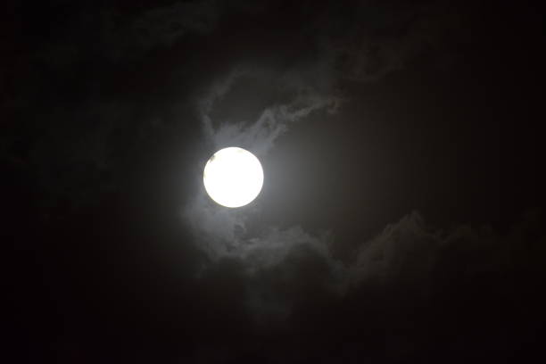istock Full moon view during cloudy night in the sky 1207452942