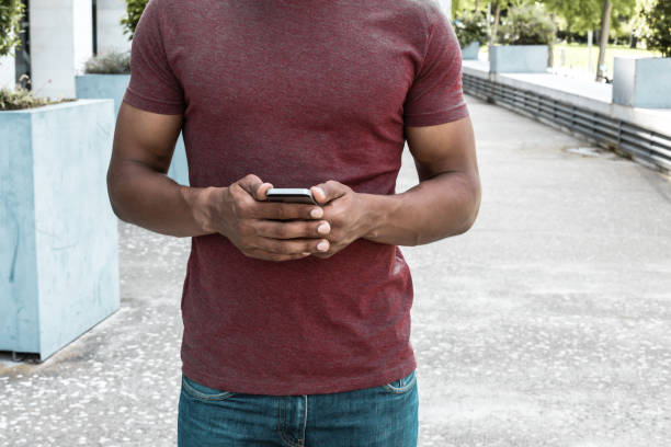istock Closeup male hands holding smartphone 1207453039