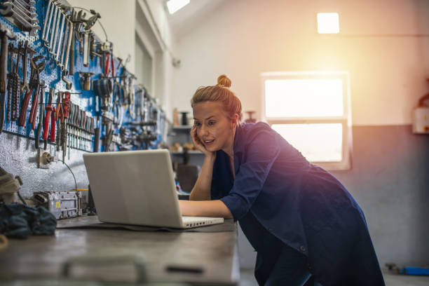istock Female mechanic using laptop in a workshop. 1207453197