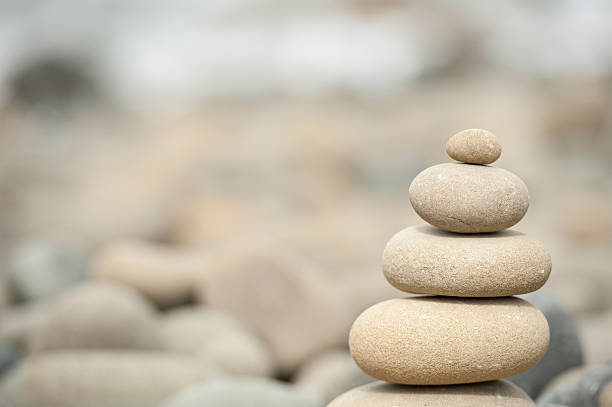 istock pile of balanced stones on rocky beach 120745454