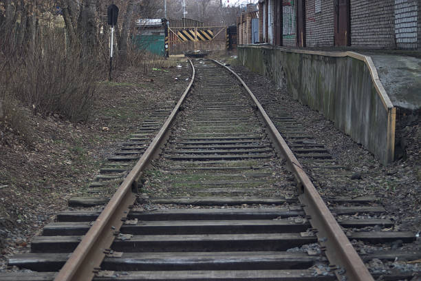 istock railway dead end near the warehouse building 1207454903