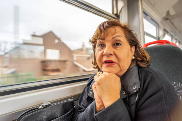istock Senior Hispanic woman on train 1207455081