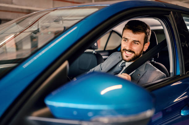 istock Businessman fastening seatbelt before his trip by car. 1207455105