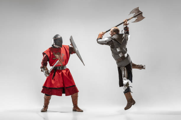 istock Brave armored knights fighting isolated on white studio background 1207456941