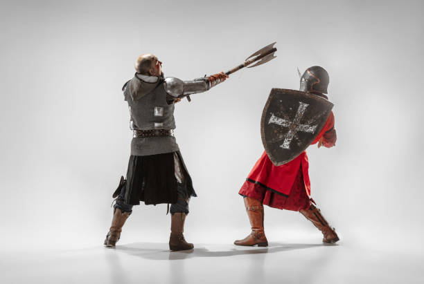 istock Brave armored knights fighting isolated on white studio background 1207456954