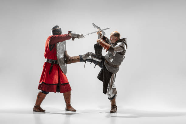 istock Brave armored knights fighting isolated on white studio background 1207456965