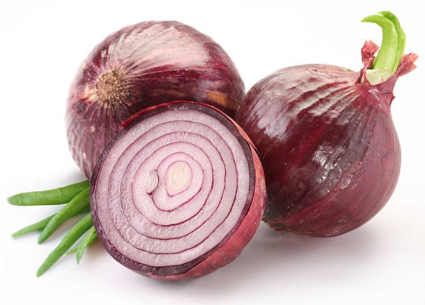 istock Bulbs of red onion with green leaves 120745711