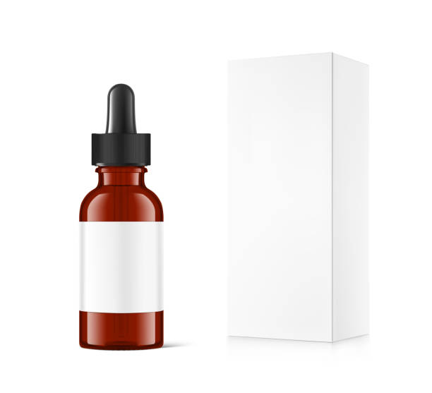 istock Realistic cardboard packaging box mockup with amber dropper bottle mockup isolated on white background. 1207458576