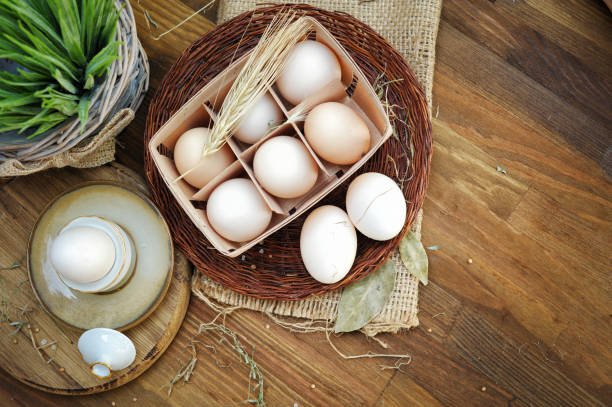 istock Fresh farm eggs on a wooden background 1207458720