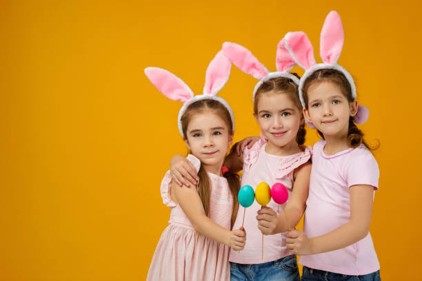istock child girls holding painted Easter eggs 1207458733