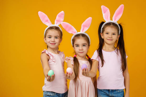 istock child girls holding painted Easter eggs 1207458766