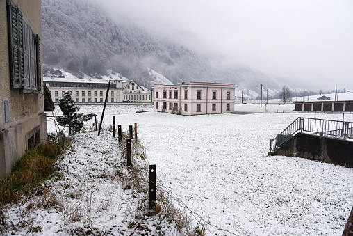 Diesbach in the canton of Glarus with its old textile factory building. The image was captured during winter season.