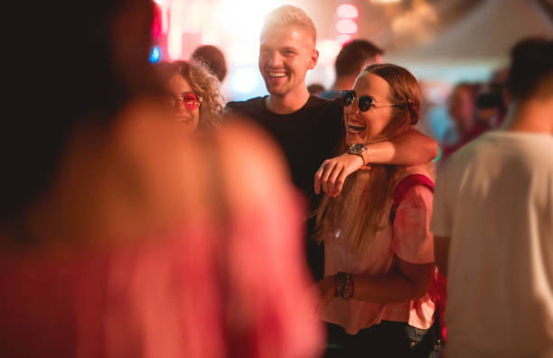 istock Friends  walking through crowd and laughing 1207462698