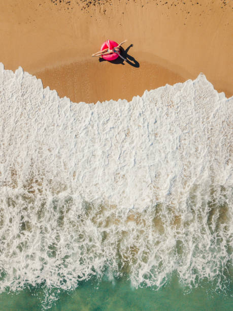 istock Happy woman relaxing on the beach 1207464153