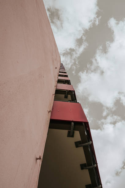 istock a high-rise with small red balkons with a view from below 1207465296
