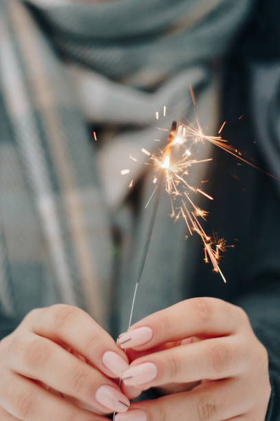 istock girl with sparkler in hands one body 1207467059