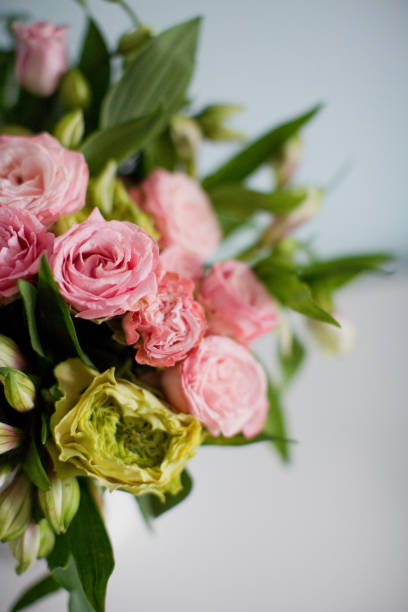 istock Bright bouquet with roses, eustoma and alstroemeria in white vase. 1207467108