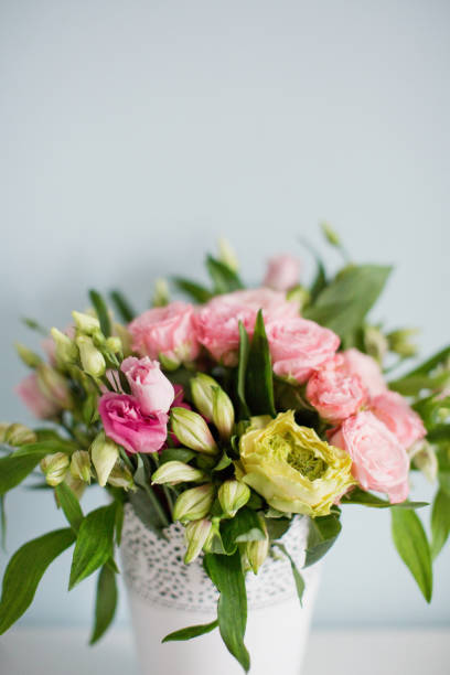 istock Bright bouquet with roses, eustoma and alstroemeria in white vase. 1207467125