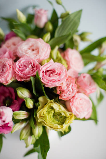 istock Bright bouquet with roses, eustoma and alstroemeria in white vase. 1207467133