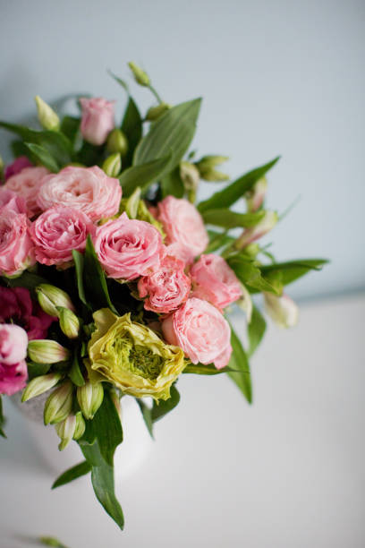 istock Bright bouquet with roses, eustoma and alstroemeria in white vase. 1207467149