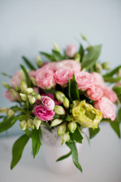 istock Bright bouquet with roses, eustoma and alstroemeria in white vase. 1207467153