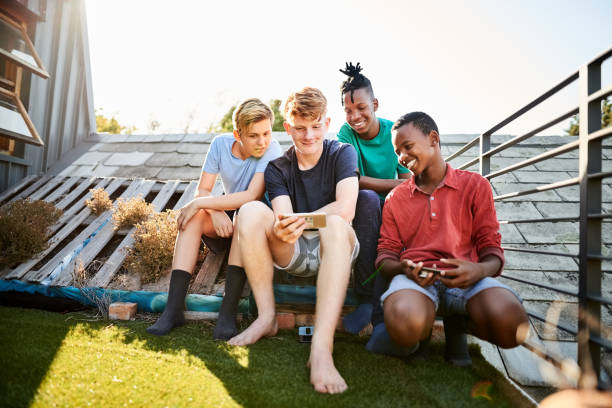 istock Friends watching a video on a mobile phone 1207467366