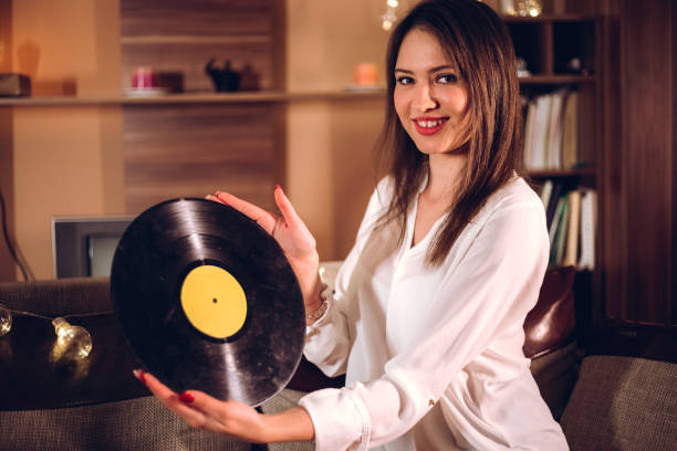istock Woman with old vinyl record 1207468652