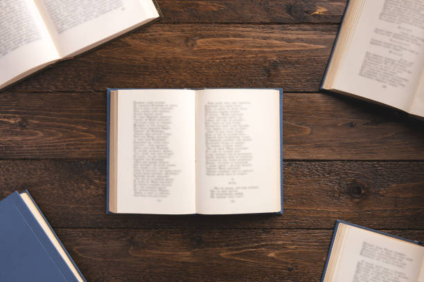 istock Open books with poems, isolated on wooden background. Flat lay, top view, copy space. 1207470236