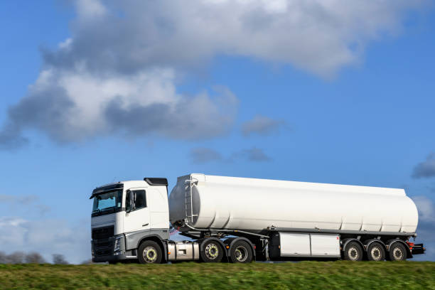 fuel tanker semi-truck with a freight cargo trailer driving on the road - speed horizontal commercial land vehicle automobile industry imagens e fotografias de stock