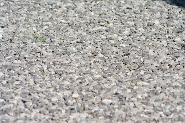 istock small road stone background, dark gravel pebbles stone texture 1207470968