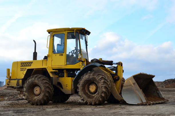 istock Front-end loader working on construction site during the renovation of the road 1207471861