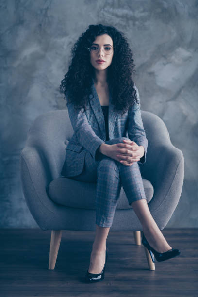 istock Vertical view portrait of her she nice attractive pretty classy chic content serious wavy-haired girl shark sitting in chair crossed legs job seeker attending meeting gray concrete wall background 1207473414