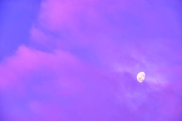 istock Moon appears behind some beautiful pink clouds on sky 1207473575