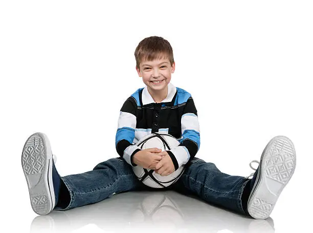 Portrait of the boy with a ball on a white background