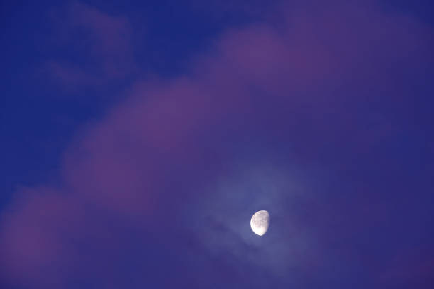 istock Moon appears behind some beautiful pink clouds on sky 1207473901