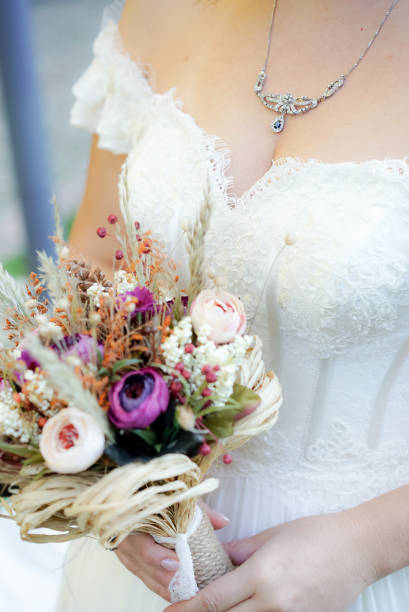 istock Brides with bridal flowers in their hands 1207474855