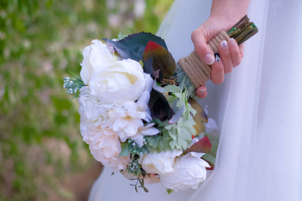 istock Brides with bridal flowers in their hands 1207474956