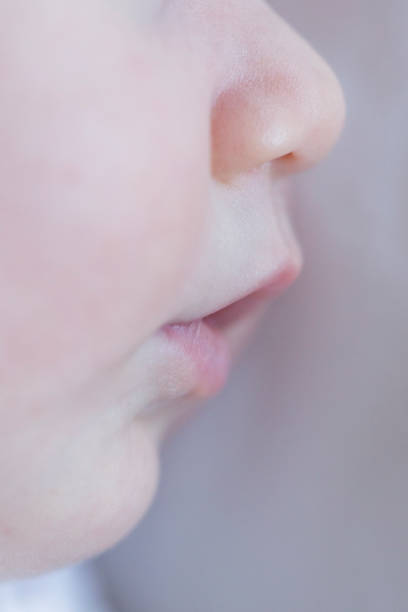 istock close up sleeping baby lips view. side portrait, macro photography. 1207475809