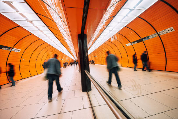 istock Colourful subway station with motion blurred people passing pedestrian tunnel 1207477736