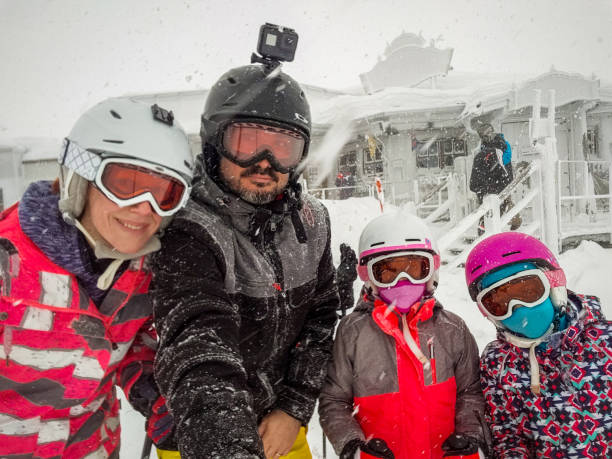 istock Family on winter vacations taking selfie on mountain slope. 1207477863