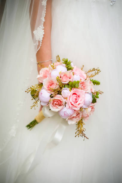 istock Brides with bridal flowers in their hands 1207477916
