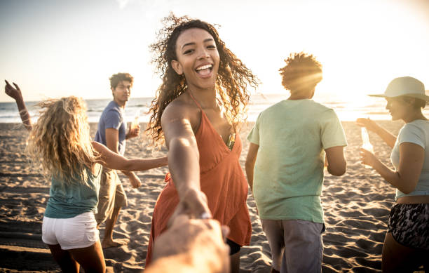 istock Group of friends having fun on the beach making a bonefire 1207481015