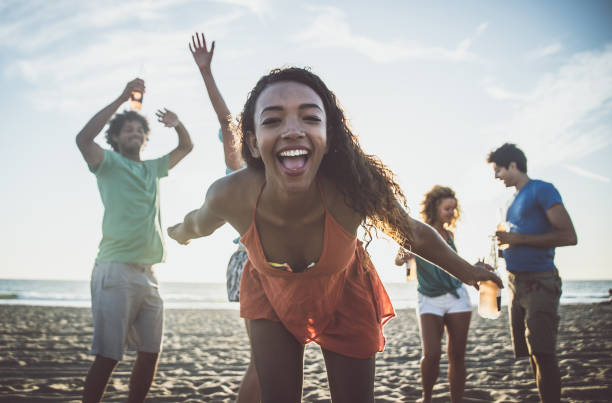 istock Group of friends having fun on the beach making a bonefire 1207481153