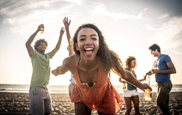 istock Group of friends having fun on the beach making a bonefire 1207481176