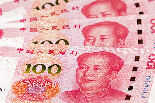 Collage of New Chinese 100 RMB or Yuan featuring Chairman Mao on the front of each bill