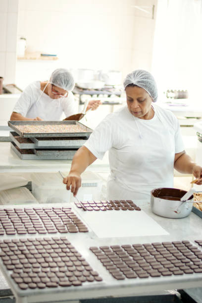 istock Woman preparing chocolate in a chocolate factory 1207483674