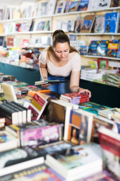 istock Woman buying textbooks 1207484011